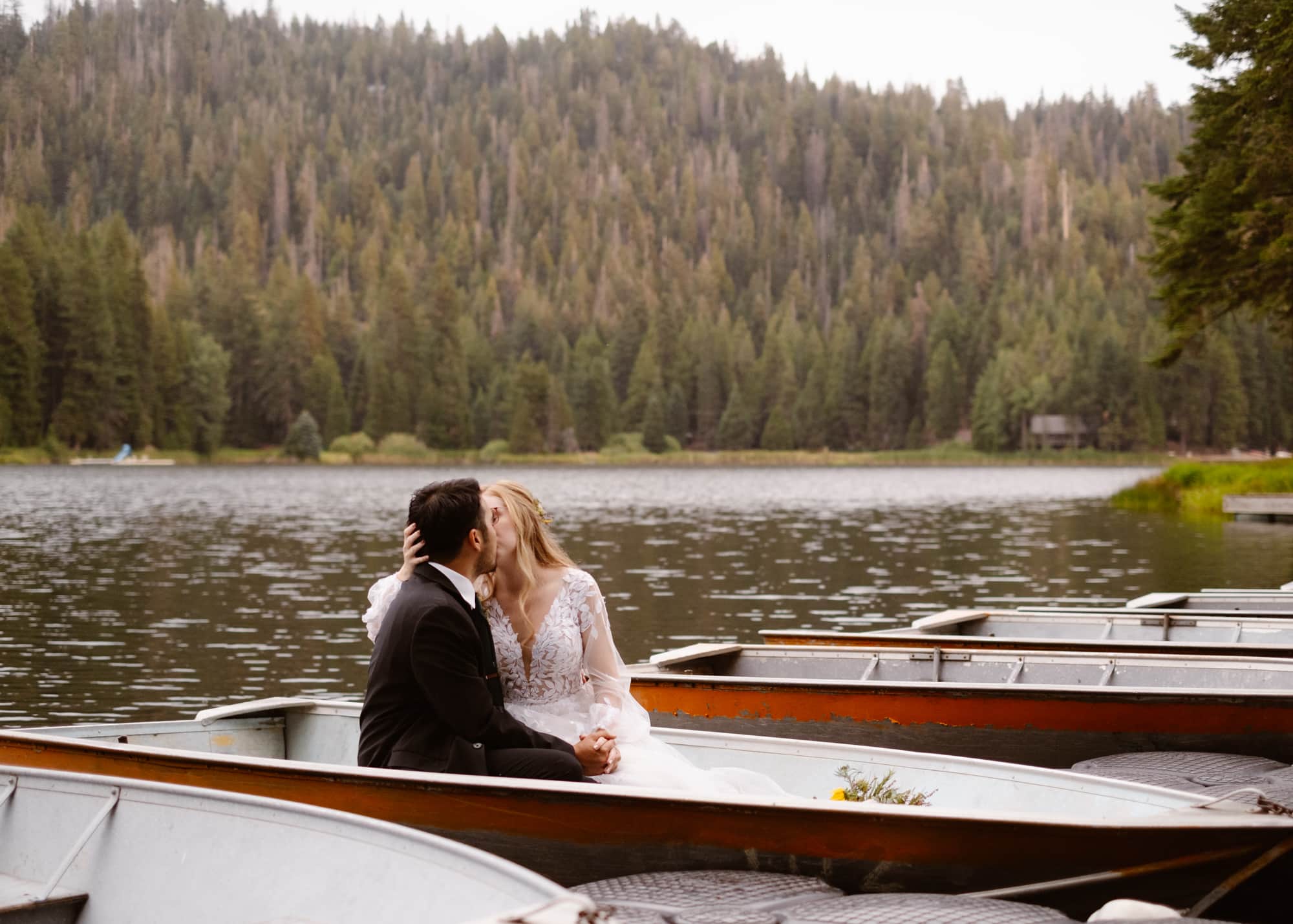 A couple opts sitting inside a canoe on a lake in Sequoia National Park as their unique elopement activity idea.